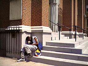 A homeless man sleeping outside a church
